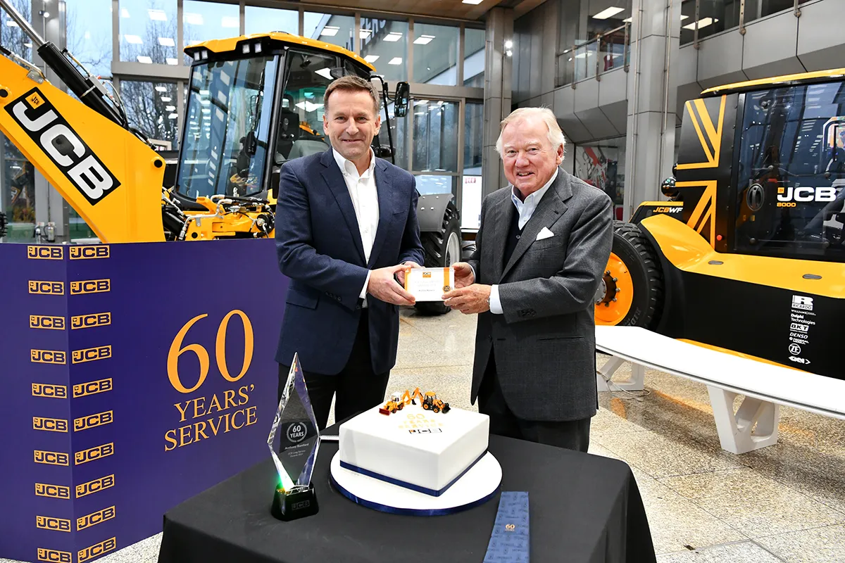 JCB Chairman Anthony Bamford celebrates an unprecedented milestone with the family firm this weekend – 60 years’ service. Having completed an engineering apprenticeship with Massey Ferguson in France, he first walked through the doors of the company’s Rocester factory as an employee on February 24th, 1964 aged just 18 and started work on the shop floor. Fast forward 60 years and Lord Bamford’s thirst for work continues at the age of 78 as he leads a £100 million project to develop hydrogen combustion engines to power the JCB machines of the future. Lord Bamford was presented with his long service award at the JCB World Headquarters by JCB CEO Graeme Macdonald. He also received a gift of an oak tree from company Directors. As he reflected on the 60-year milestone, Lord Bamford said: “It is hard to imagine that I have been here that long, but I really haven’t known anything else. As a family company, I was introduced to the business at a very young age and have been involved in it ever since. In fact, my earliest memory was going with my mother to take tea and sandwiches to a handful of men who were working for my father when the business was based in stables at Crakemarsh Hall, near Uttoxeter. So much has happened over the past 60 years. When I first worked at JCB, we had one factory. Now there are 22 all over the world employing more than 19,000 people. We were also making around 3,000 machines a year in 1964 and today we manufacture well over 100,000 every year. JCB’s success is very much down to the whole team around the world and, while it’s nice to reflect on the achievements of the past, my focus is very much on what our team can achieve in the future.” JCB CEO Graeme Macdonald said: “The whole JCB team sends its congratulations to Lord Bamford on what is a momentous milestone. Such an achievement is unprecedented at JCB and almost certainly unmatched in British industry. Lord Bamford’s contribution to JCB and the business world over the past 60 years has been truly remarkable.” Anthony Bamford’s personal career highlights include the establishment of JCB’s first overseas subsidiary in France in 1969. In 1979, four years after taking over as Chairman from his father, the late Joseph Cyril Bamford CBE, he established JCB’s business in India, which has since grown into the company’s biggest single market for construction equipment. Under Lord Bamford’s leadership, JCB has grown to into one of the world’s largest and most successful construction equipment manufacturers with 11 factories in the UK, and others in India, North America, Brazil, and China. When Lord Bamford joined JCB in 1964, the company’s turnover was £8.9 million; in 2022 it had risen to £5.7 billion. Lord Bamford was also instrumental in setting up The JCB Academy in Rocester, which opened in September 2010, a £22 million school for 13-18 year-old students aspiring to become the engineers and business leaders of the future. The Academy currently has more than 800 students studying there and more than 3,200 students have attended since it first opened. The Academy also provides training for apprentices and more than 600 have graduated from the JCB Academy Apprenticeship Programme since it started in 2013.