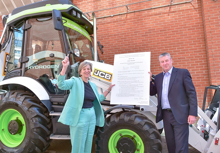 Lilian Greenwood and JCB's Tim Burnhope with the signed statutory instrument